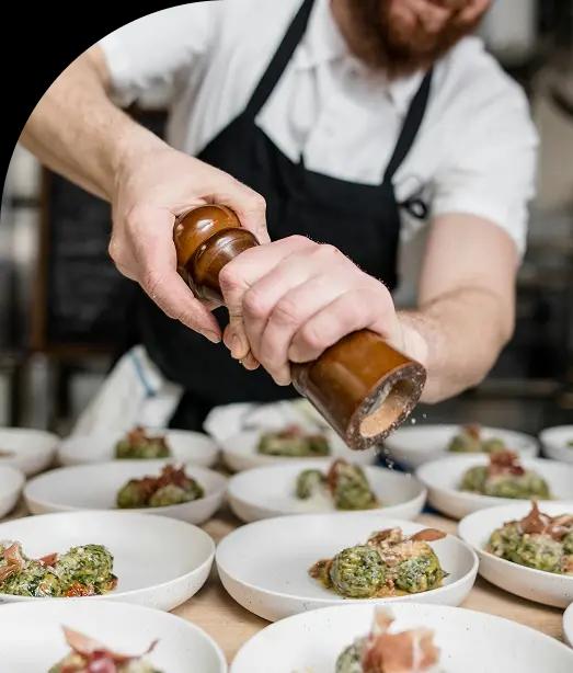 Chef grinding pepper